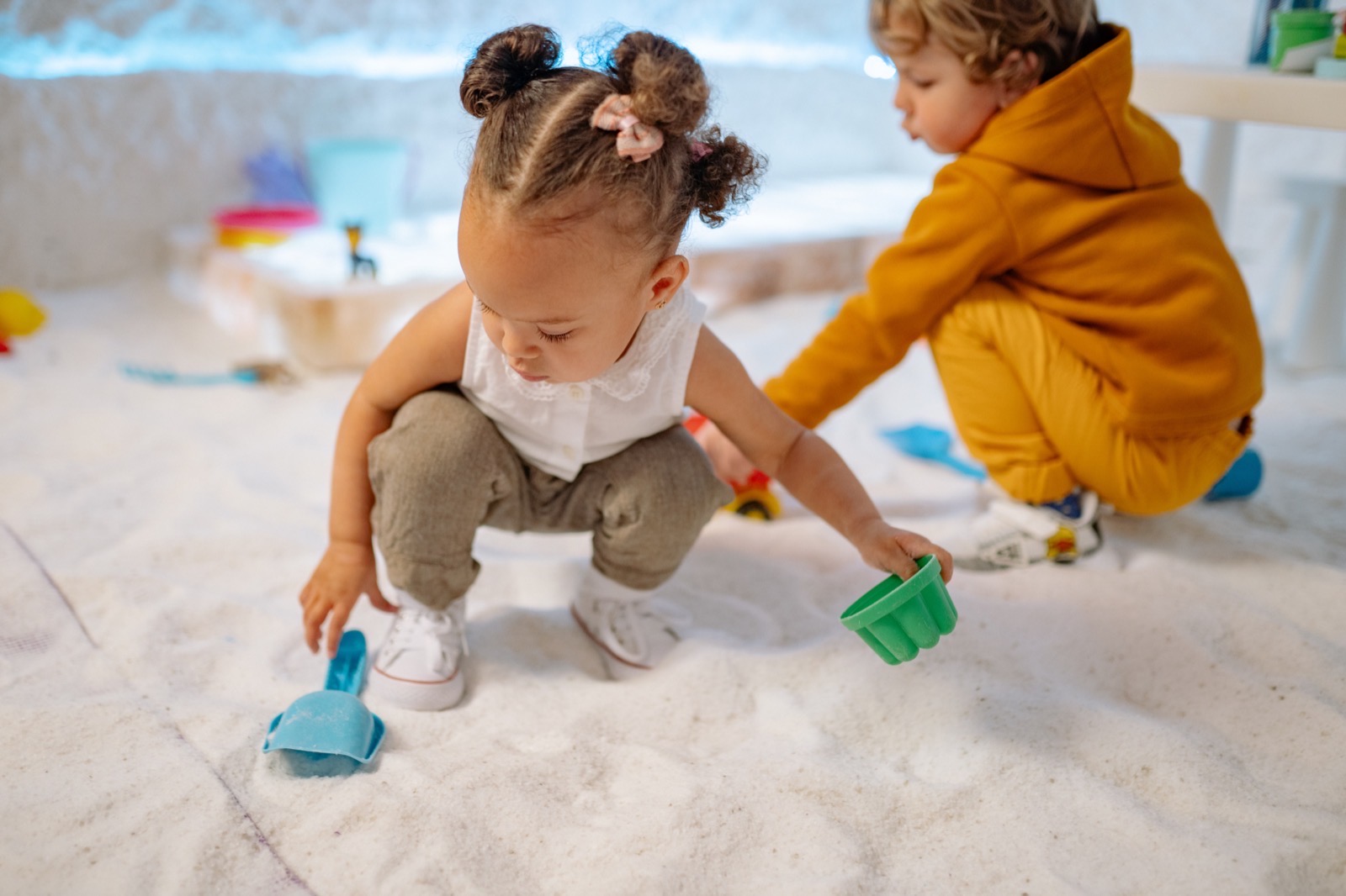 TCCU two little kids playing on the floor